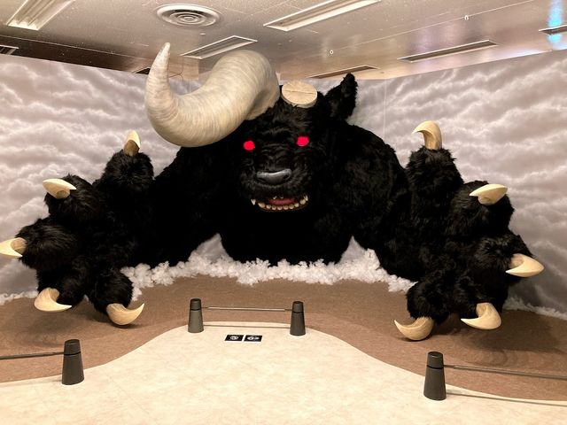 A promotional photo of a large scale diorama of Nosferatur Zodd in his demon form reaching for the audience. Nosferatu Zodd appears as a large, furry, bear-like creature with glowind red eyes, ox-like horns, and sharp claws. One of his horns has been slice away at the base of where it protrudes from his head.