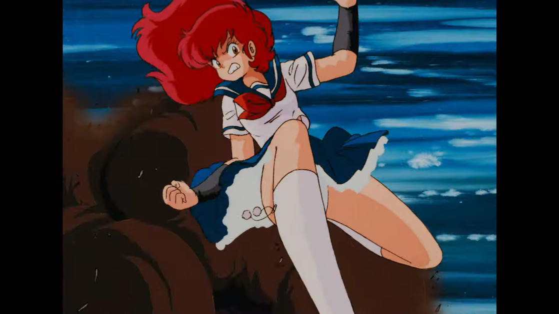 A-ko Magami, a perfectly ordinary Japanese high school girl dressed in a sailor fuku, prepares to drop-kick a giant robot in a scene from the 1986 Project A-ko anime theatrical film.