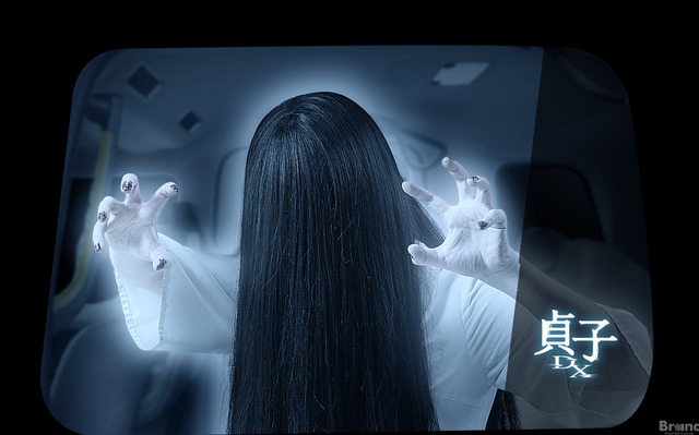 A promotional image from the "Sadako Taxi" collaboration featuring the ghostly Sadako popping out of the taxi signage via an augmented reality app.