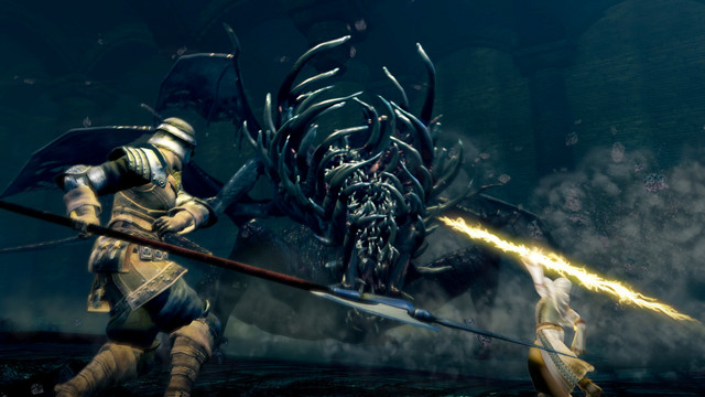 Two heroes face off against the Gaping Dragon in a promotional screencap for the Dark Souls: Remastered PC game by FromSoftware.