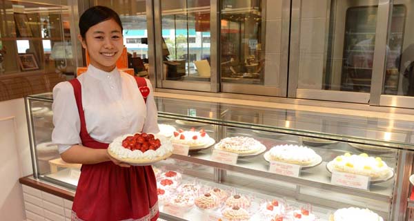 A server shows off the trademark Anna Miller's uniform and a selection of pies in a promotional image for the restaurant, which is closing its final store in Japan in August of 2022.