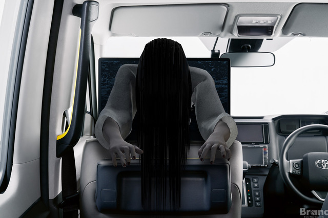 A promotional image from the "Sadako Taxi" collaboration featuring the ghostly Sadako popping out of a taxi's passenger monitor screen to provide safety instructions.