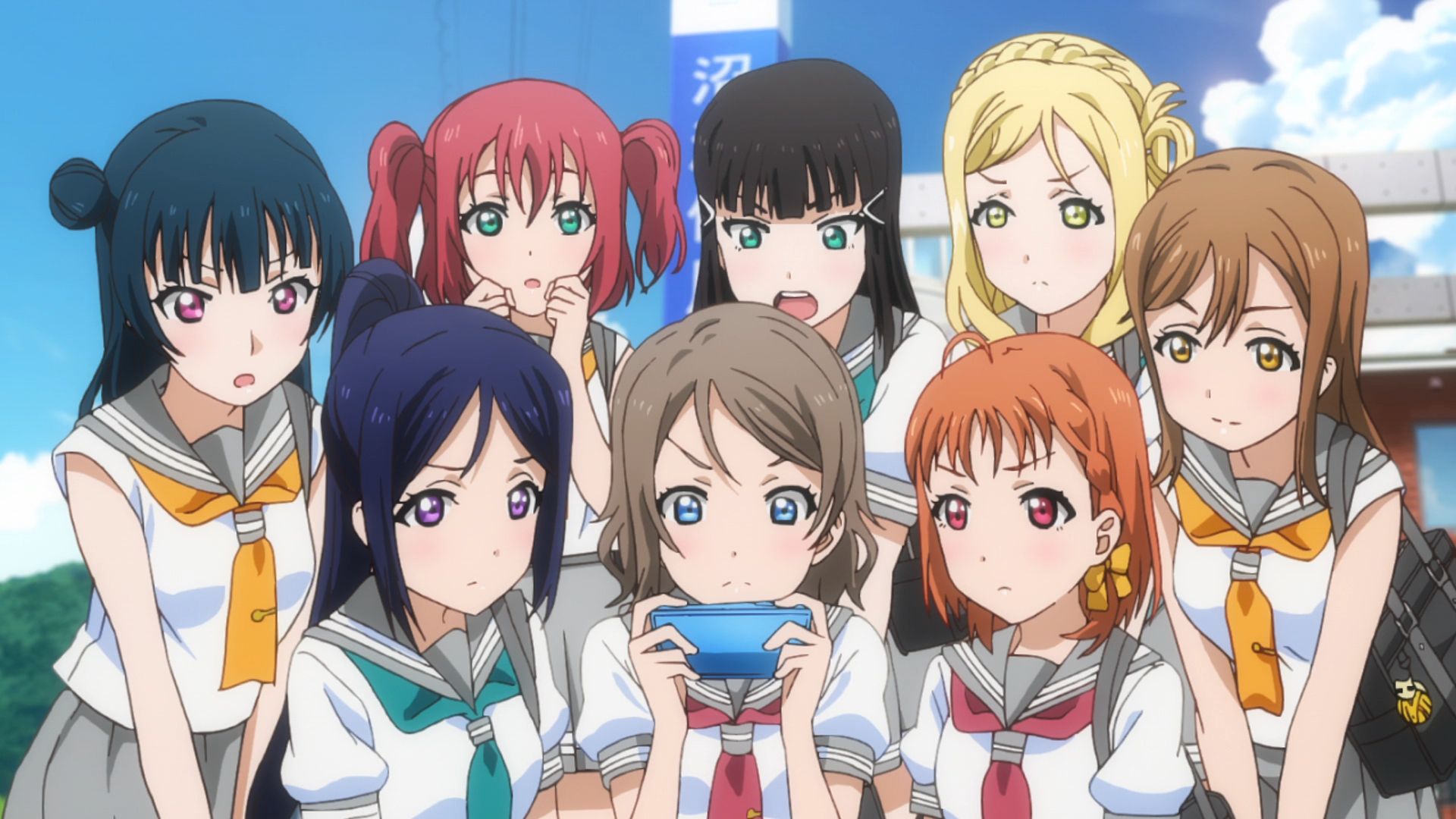 The girls of Aqours gather around a smart phone to check out the school idol rankings in a scene from the Love Live! Sunshine!! TV anime.