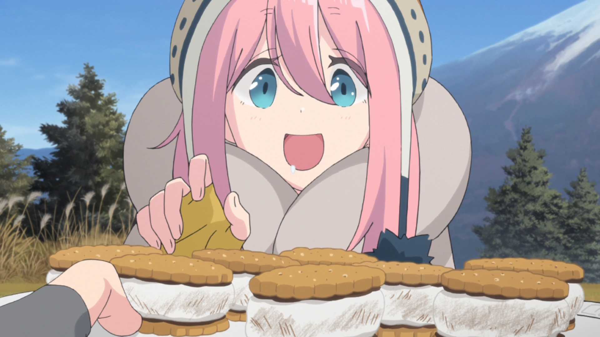 Nadeshiko Kagamihara se prepara para comer algunos S'mores en una escena del anime de televisión Laid-Back Camp de 2018.