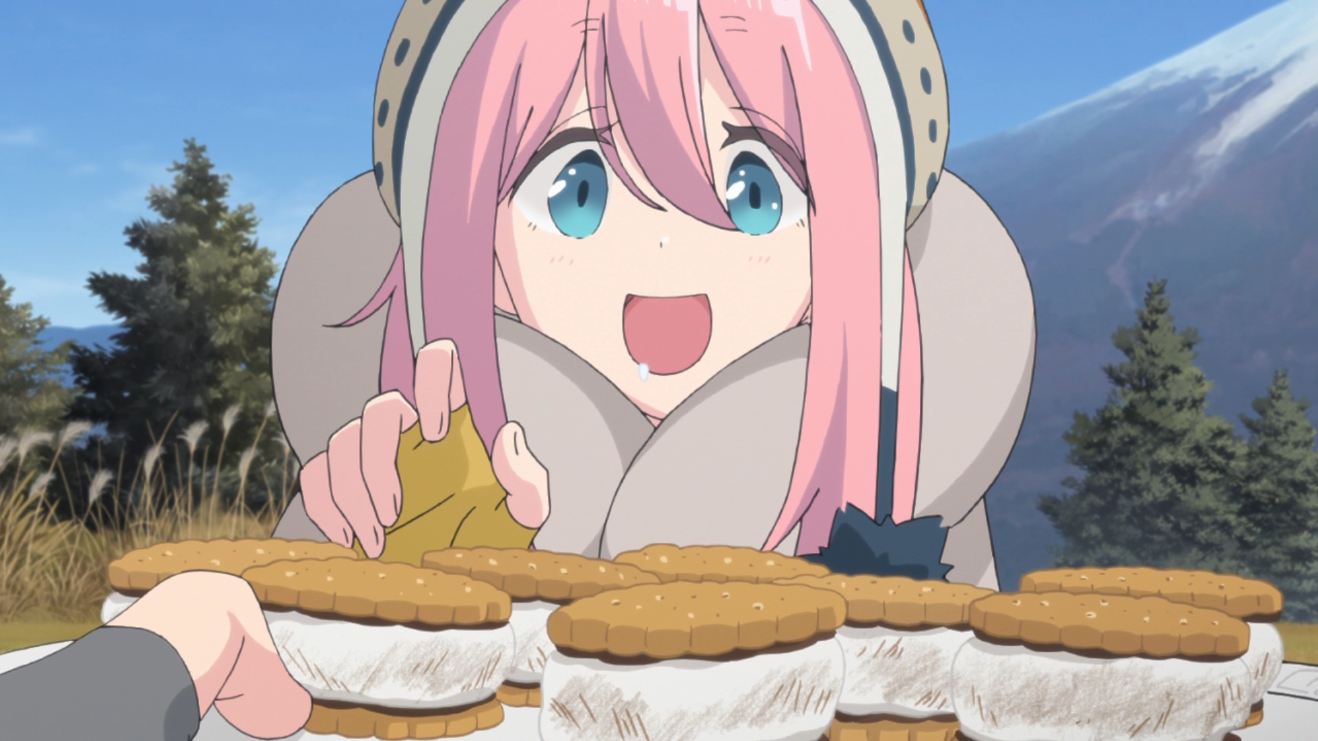 Nadeshiko Kagamihara prepares to chow down on some S'mores in a scene from the 2018 Laid-Back Camp TV anime.