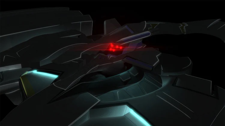 A Tactical Surface Fighter boots up within a darkened hangar in a scene from the TV CM announcing the second season of the Muv-Luv Alternative TV anime.