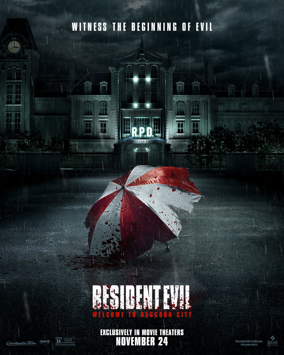 The theatrical movie poster for the upcoming Resident Evil: Welcome to Raccoon City live-action film, featuring a tattered white and red umbrella laying ominiously in front of a spooky mansion on a rain-filled night.