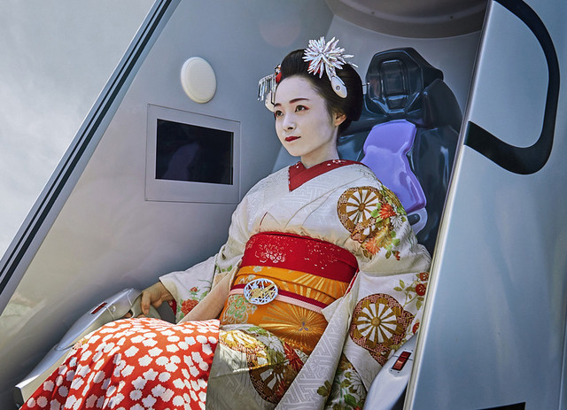 An actress dressed as a geisha tests her synchronization rate in the entry plug attraction of the Evangelion Kyoto Base at Toei Kyoto Studio Park.