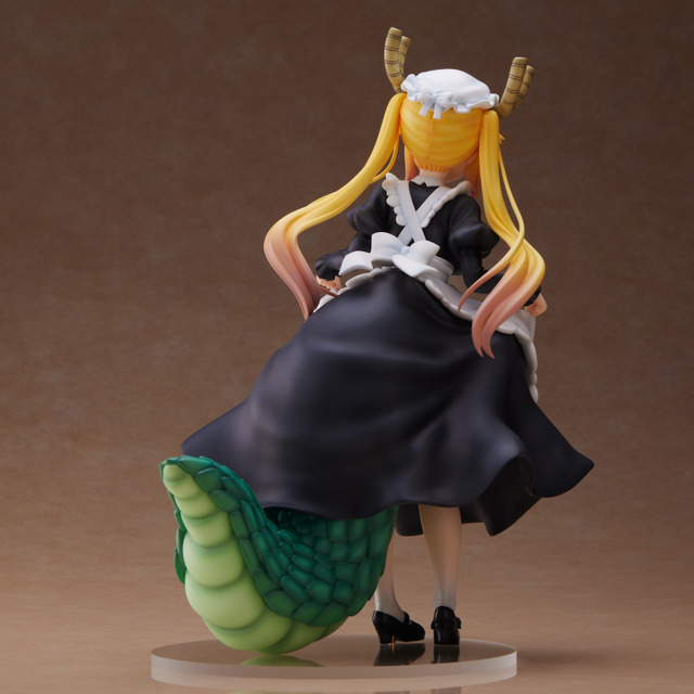 A promotional image of the Miss Kobayashi's Dragon Maid S Tohru figure from Union Creative featuring a view of the figure from the rear. Tohru's massive reptilian tail is visible poking out from beneath her skirts.