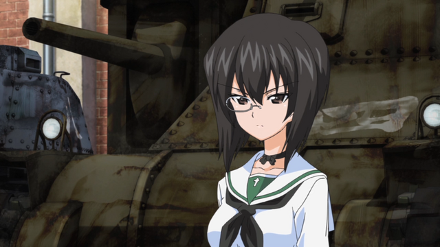 Momo Kawashima stands before a beat up old tank and glares in a scene from the 2012 GIRLS und PANZER TV anime.