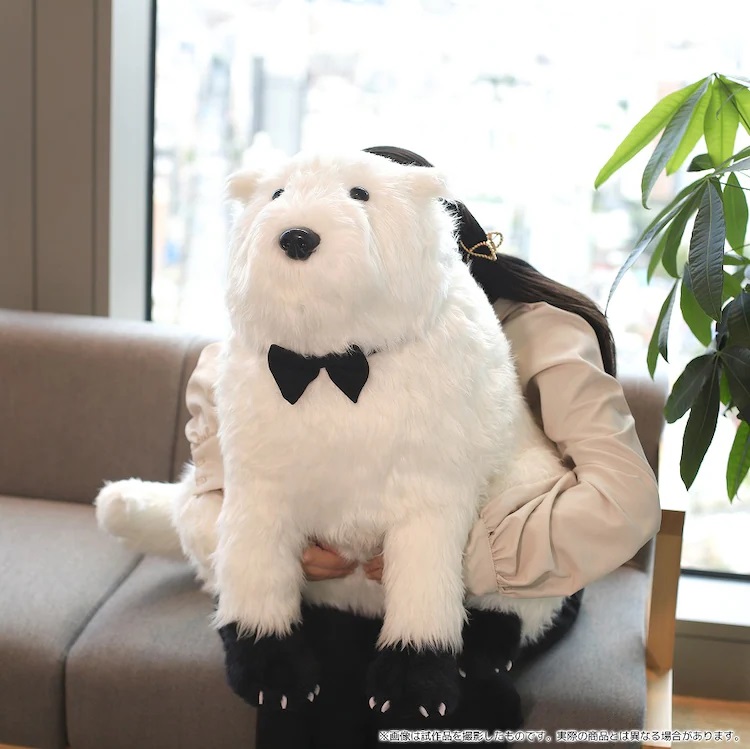 A promotional image of Movic's made-to-order Bond plush toy from the SPY x FAMILY TV anime showing a model burying her face in Bond's fur and snuggling with him.