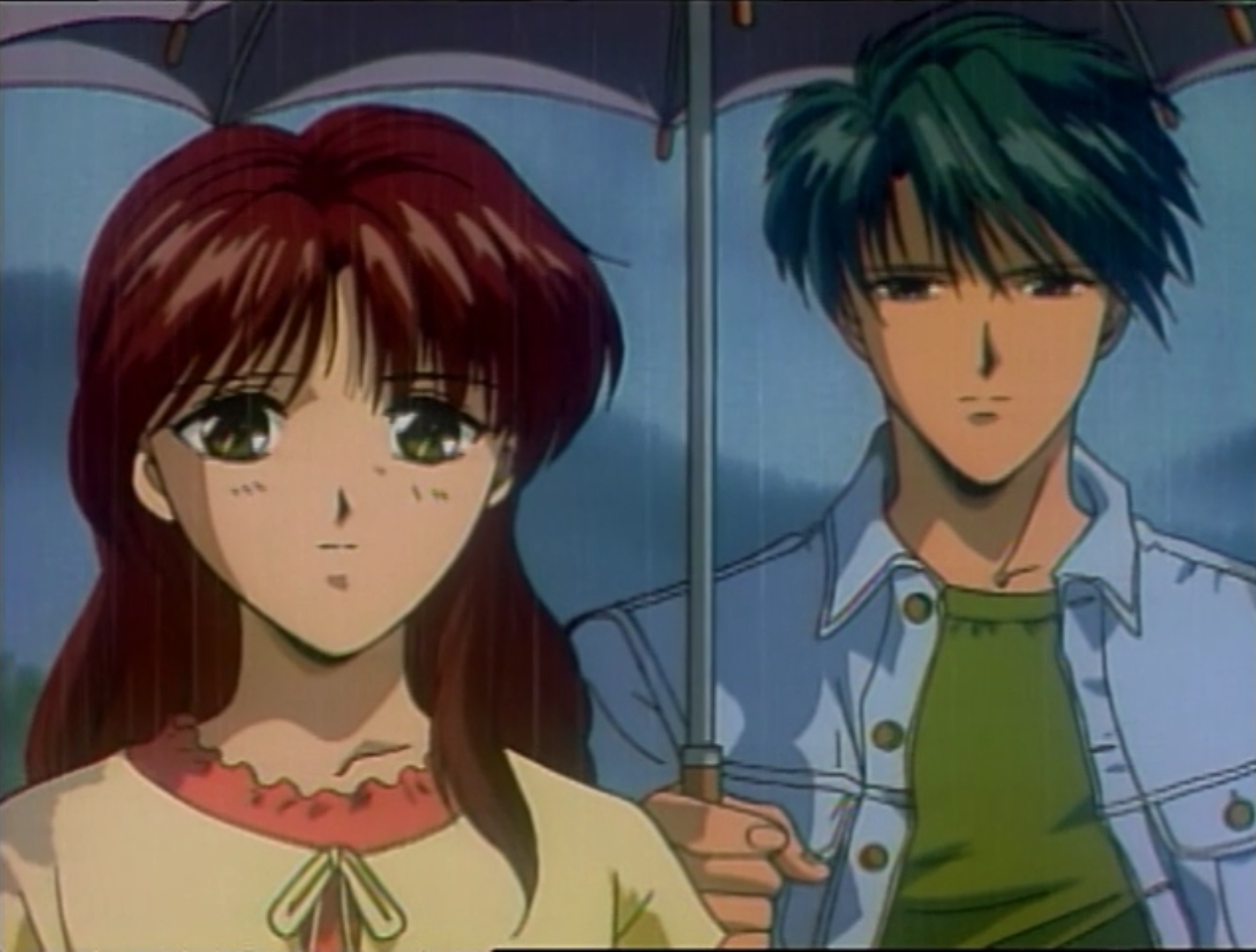 Miaka and Tamahome share an umbrella during a rainy day on Earth in a scene from the Fushigi Yugi OAV series.