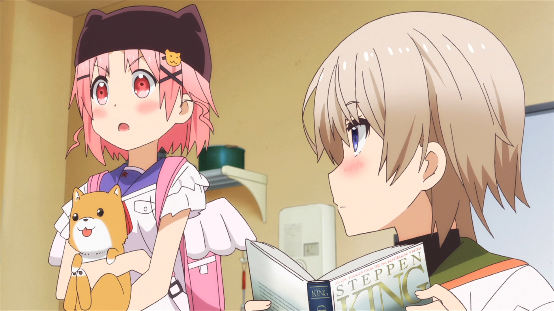 Yuki hatches a plan while Mii-kun observes from behind the pages of her Steppen King novel in a scene from the 2015 SCHOOL-LIVE! TV anime.