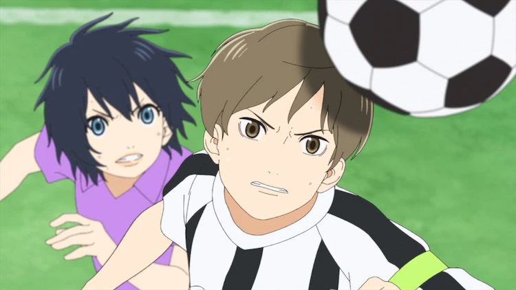 Nozomi Onda and Yasuaki Tani chase the same soccer ball in a heated match in a scene from the upcoming Farewell, My Dear Cramer - First Touch anime theatrical film.