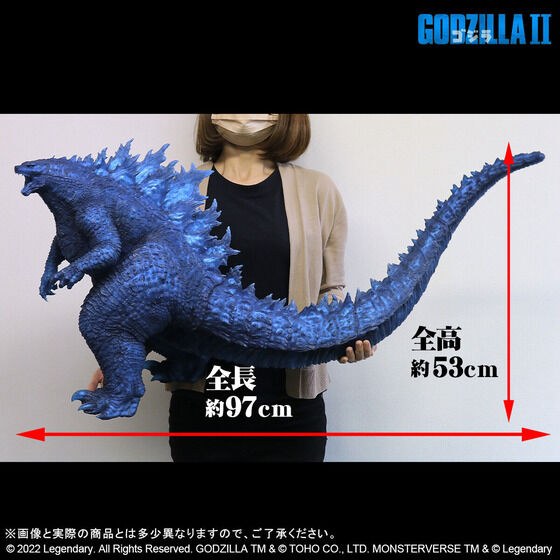 A promotional image for the "Gigantic Series Godzilla (2019) Blue Clear Ver." figure from Premium Bandai featuring a side profile view of the figure as it is held by a model with scale indicators for its length of 97 centimeters and height of 53 centimeters.