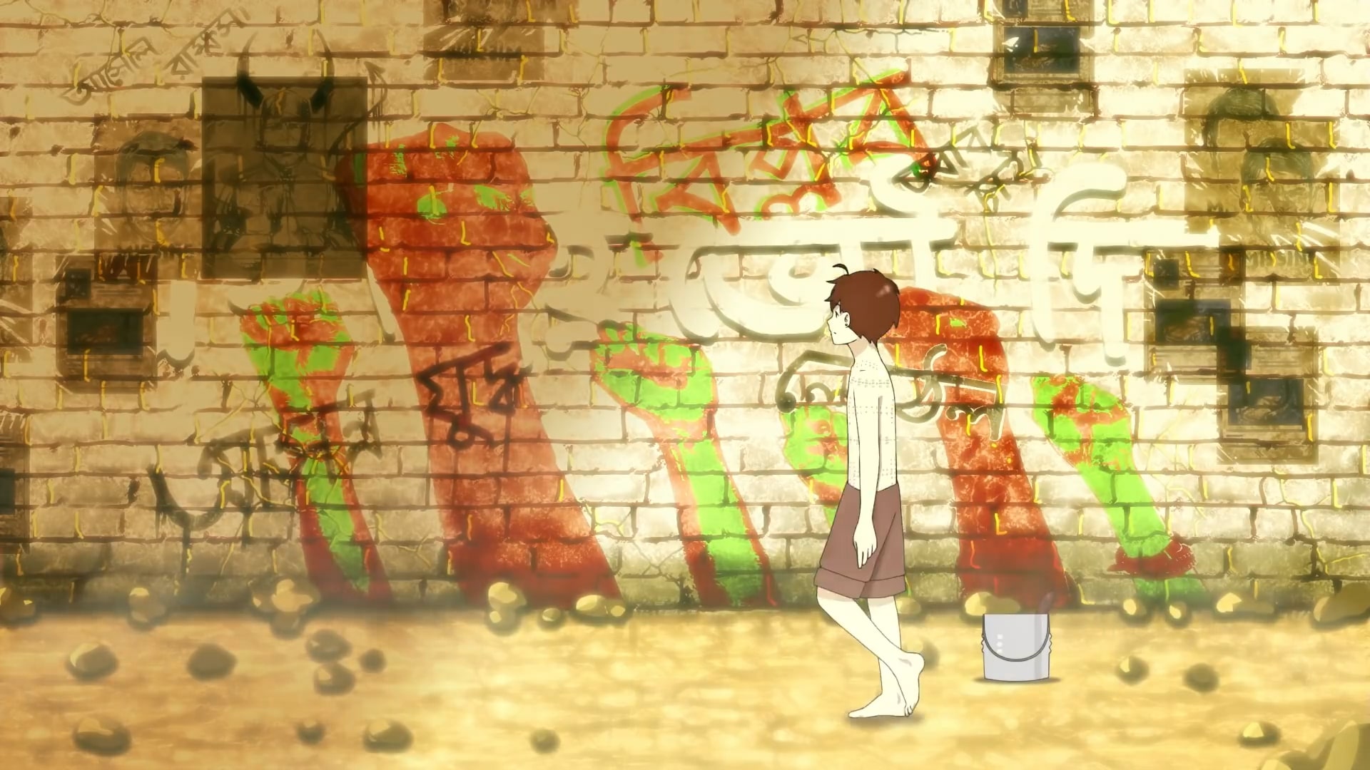 Boy stares at graffiti on a wall