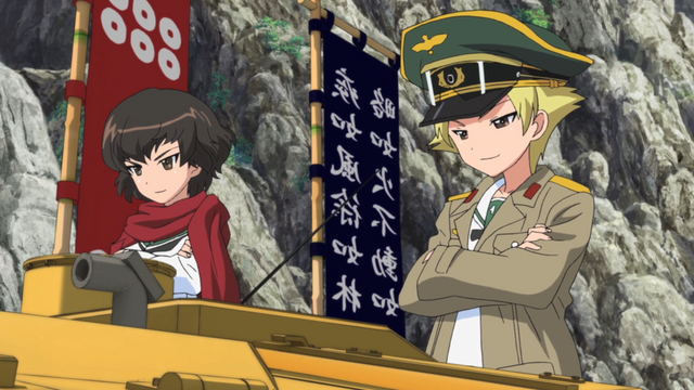 Caesar and Erwin of Hippo Team flaunt their tank's flashy paint job and banners in a scene from the 2012 GIRLS und PANZER TV anime.