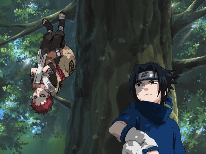 While Gaara makes a dramatic entrance hanging upside from a tree branch using only the chakra in the soles of his feet to keep a grip, Sasuke Uchiha glares up at Gaara from a perch on a lower branch in a scene from the Naruto TV anime.