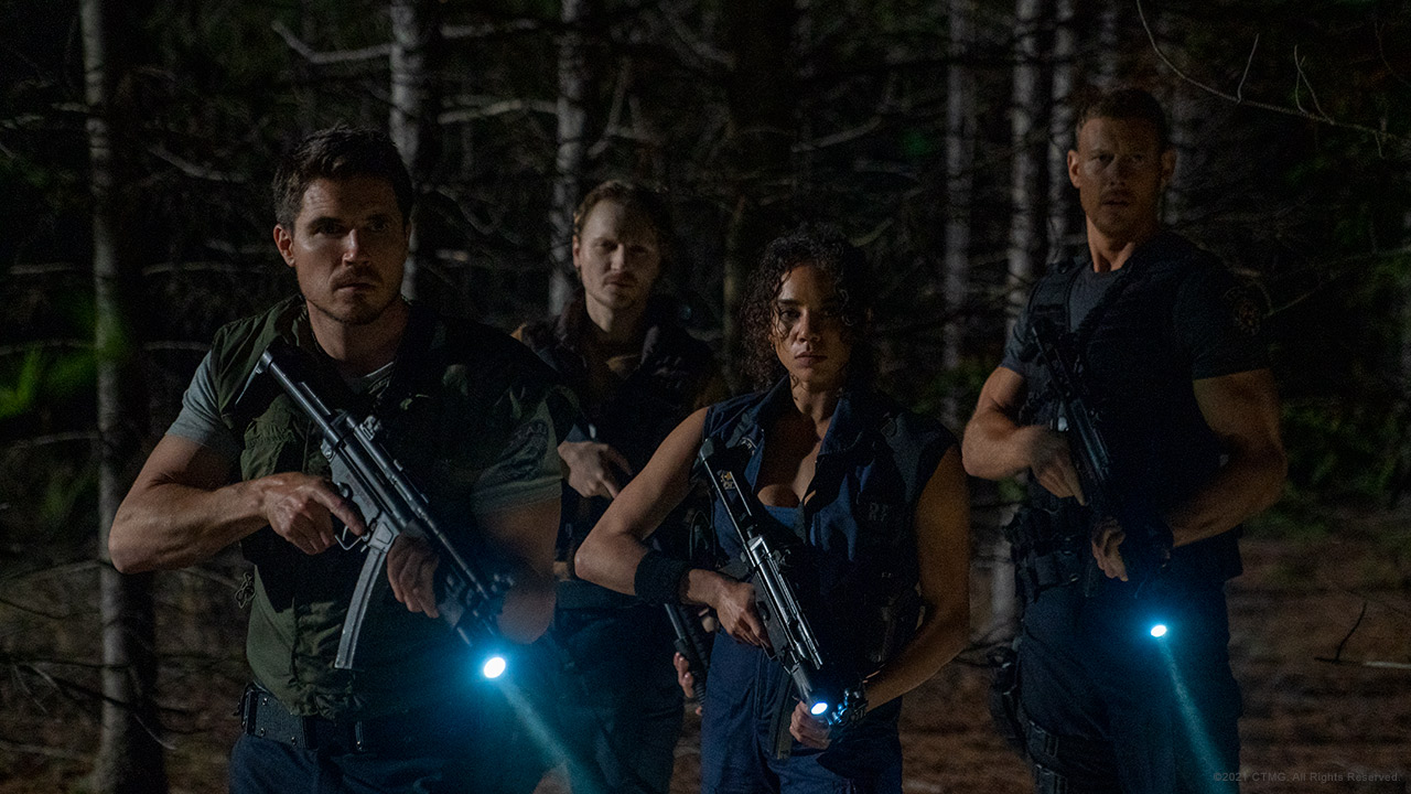 The S.T.A.R.S. squad prepares to explore a suspicious mansion in a scene from the upcoming Resident Evil: Welcome to Racoon City live-action theatrical film.