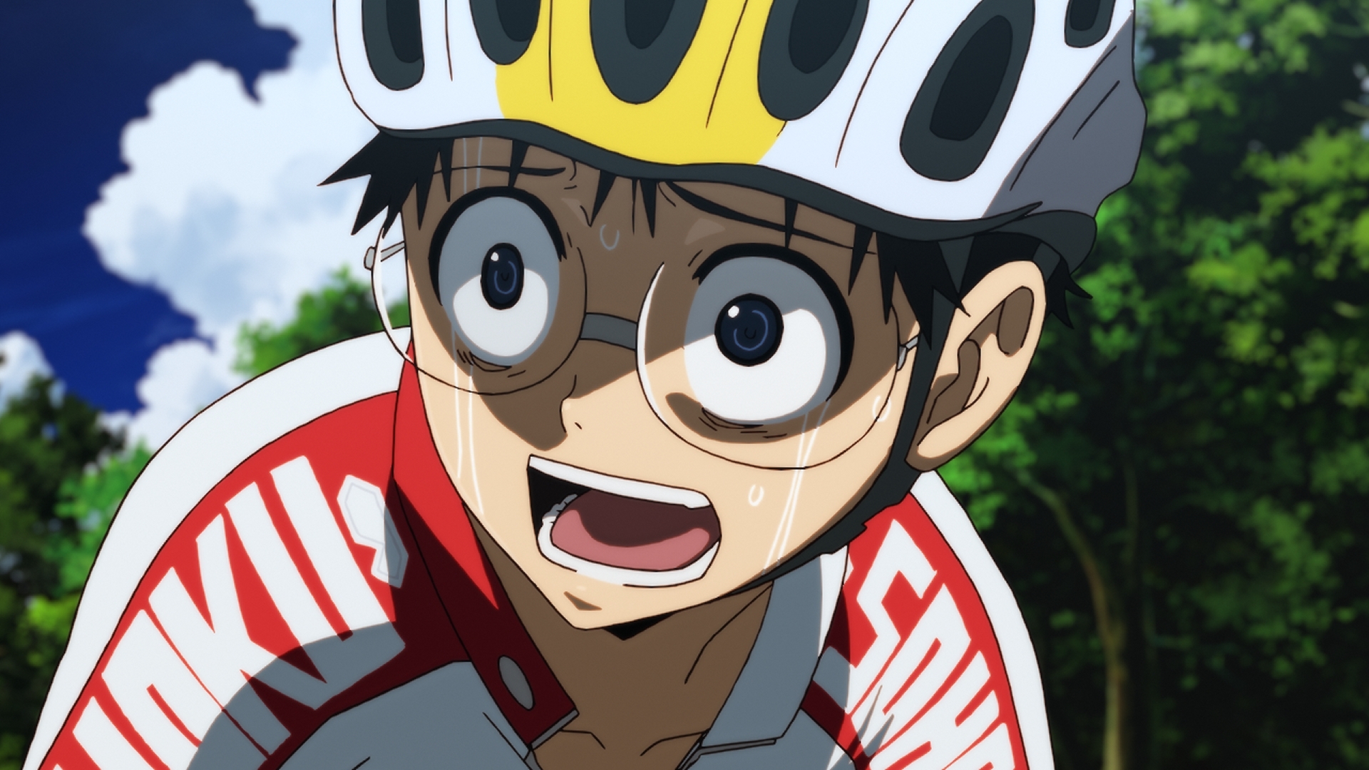 Sakamichi Onoda expresses a look of surprise and shock while riding his bicycle in a scene from the Yowamushi Pedal TV anime.