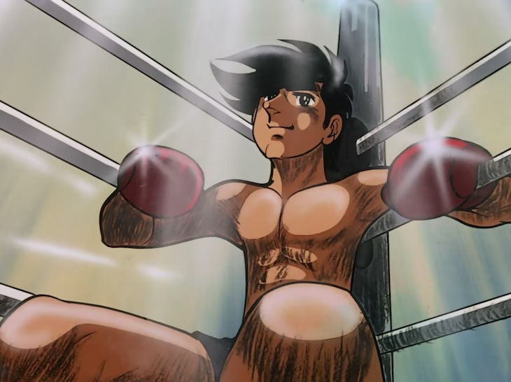 Sitting in his corner during a match in the boxing ring, Joe Yabuki smiles and leans on the ropes in a scene from the 1970 - 1971 TV anime, Ashita no Joe.