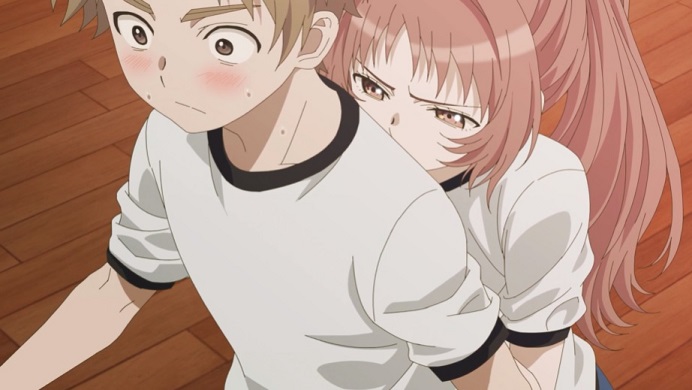 In gym class during a dodgeball match, heroine Ai Mie crowds her classmate Kaede Komura from behind in an effort to see better in a scene from the upcoming The Girl I Like Forgot Her Glasses TV anime.