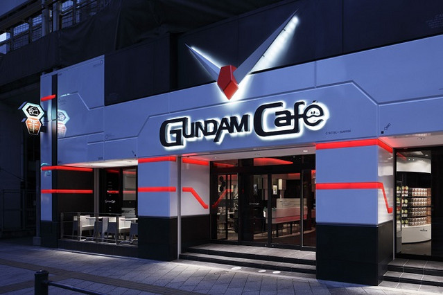 A photo of the exterior of the GUNDAM Café Akihabara location, taken during the evening.