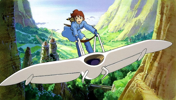 Princess Nausicaa and her fox-squirrel companion Teto sour on her glider above the peaceful Valley of the Wind in a promotional image for the 1984 theatrical anime film, Nausicaa of the Valley of the Wind.