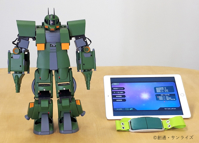 A promotional photo of the miniature Zaku toy, a tablet computer running the ZEONIC TECHNICS smart phone software, and the XB-01 sensor for the "ZEONIC TECHNICS Robotics and Programming Course I" experiment.