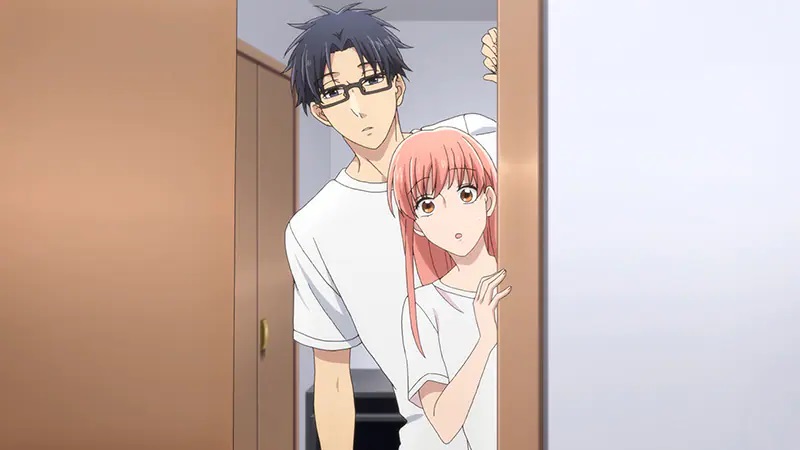 Well-dressed in matching white T-shirts, Narumi Momose and Hirotaka Nifuji peek through a doorway in a scene from the 2018 Wotakoi: Love is Hard for Otaku TV anime.