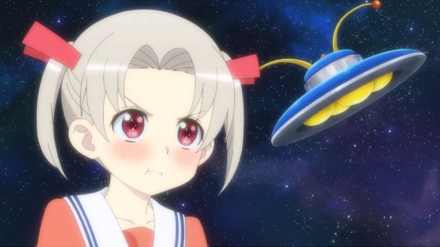 Rikka, an alien invader disguised as a human high school girl, pouts in front of an image of the galaxy and her UFO in a scene from the upcoming 4-nin wa Sorezore Uso wo Tsuku TV anime.