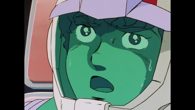 El piloto de Mobile Suit Amuro Ray expresa conmoción y consternación en una escena del anime de televisión Mobile Suit Gundam de 1979.