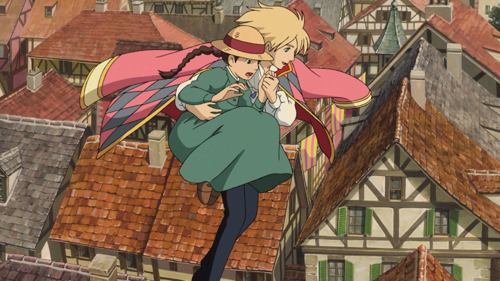 Howl and Sophie soar above the city streets in a scene from the Howl's Moving Castle theatrical anime film.