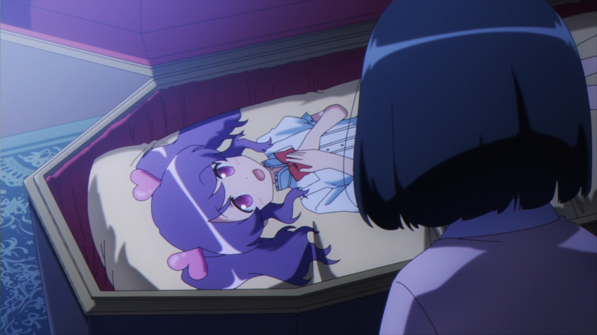 Akari Amano discovers an embarrassing hug pillow inside Sophie's coffin in a scene from the Ms. vampire who lives in my neighborhood. TV anime.