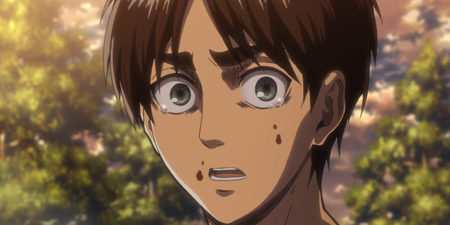 A close-up of Eren Jaeger's distraught face in a scene from the Attack on Titan TV anime.