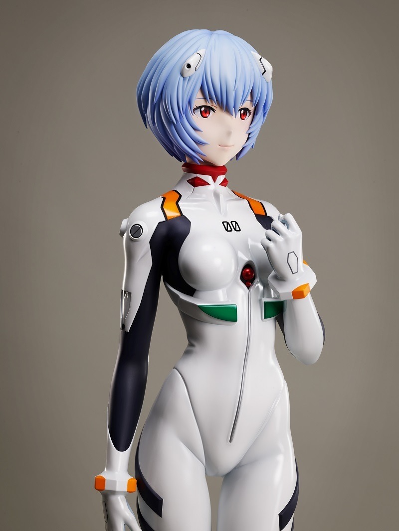 Ein Werbebild der 1: 1-Figur von Rei Ayanami aus F: NEX mit einer mittleren Aufnahme eines Prototyps der Figur im 3/4-Profil.