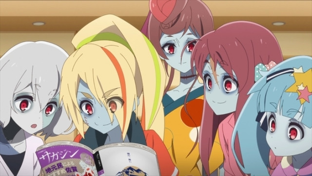The girls of Franchouchou gather around a local magazine in a scene from the ZOMBIE LAND SAGA TV anime.