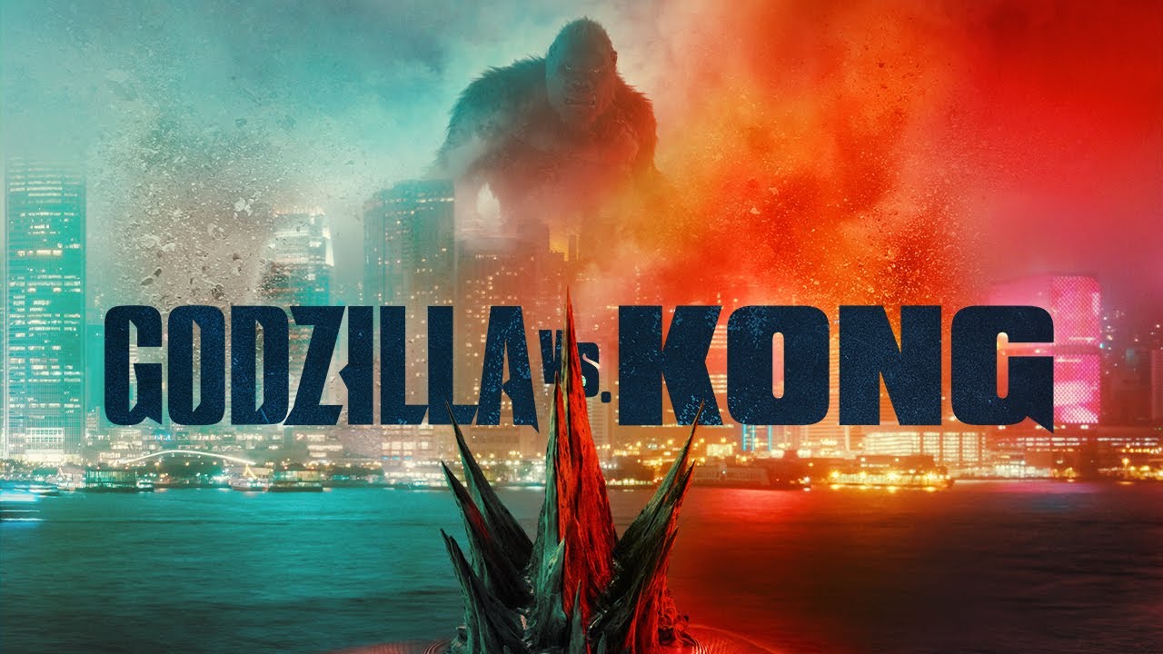 Ein Werbebild für den Film „Godzilla vs. Kong“ von Legendary Pictures aus dem Jahr 2021, in dem King Kong auf Godzillas Ankunft in Hongkong wartet.  King Kong steht mit einem knurrenden Gesicht zwischen den Wolkenkratzern, während Godzillas Flossen aus dem Wasser der Bucht herausragen, während er näher schwimmt.